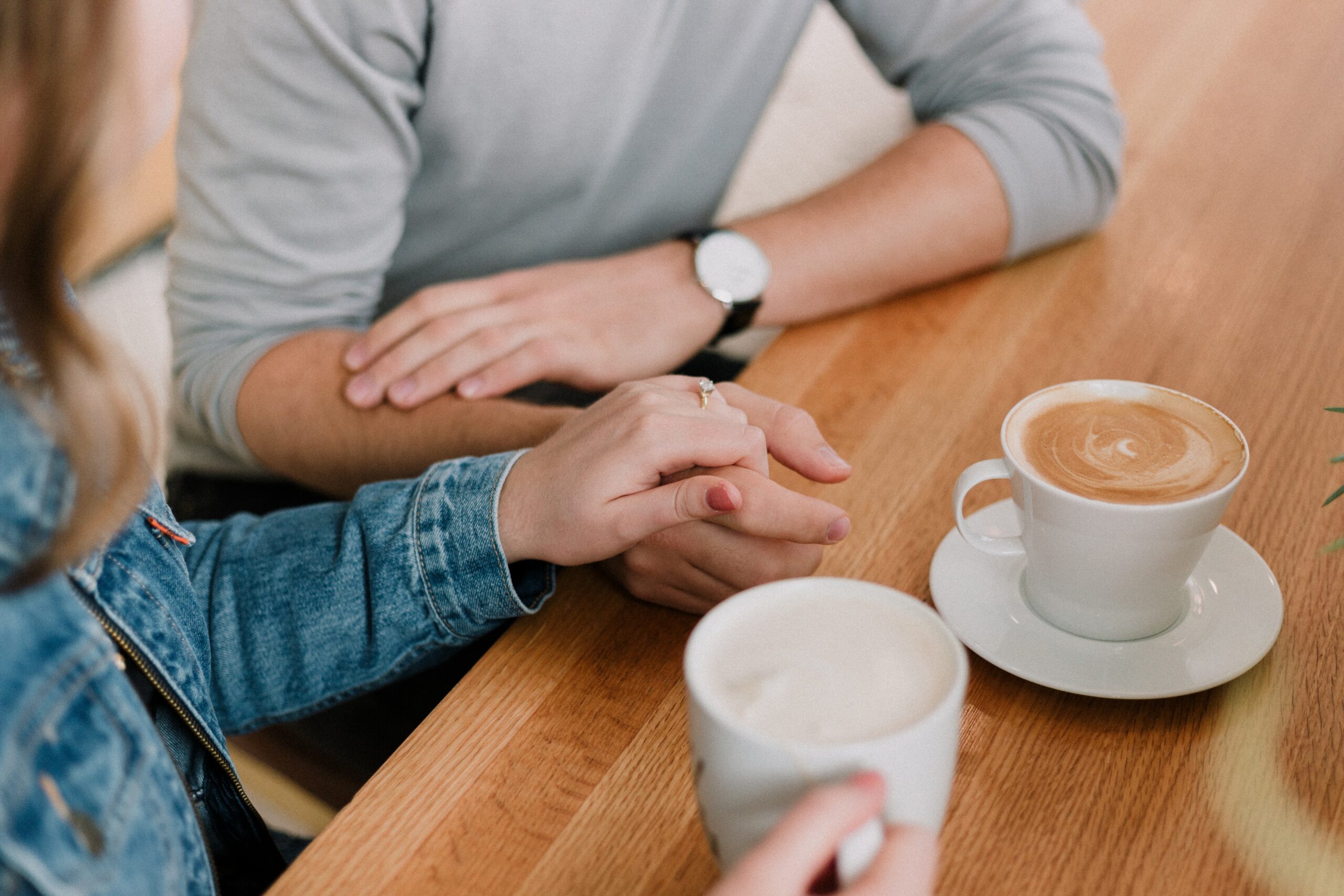 Picture of Couple sitting on chairs with hand to hand