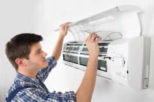 Man doing AC Maintenance | AC maintenance tips during Summer