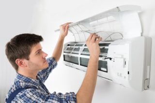 Man doing AC Maintenance | AC maintenance tips during Summer