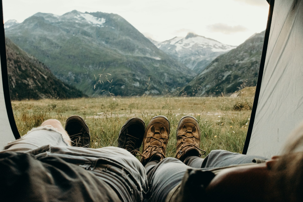 Picture of Camping Couple lying on Tent in Mountains