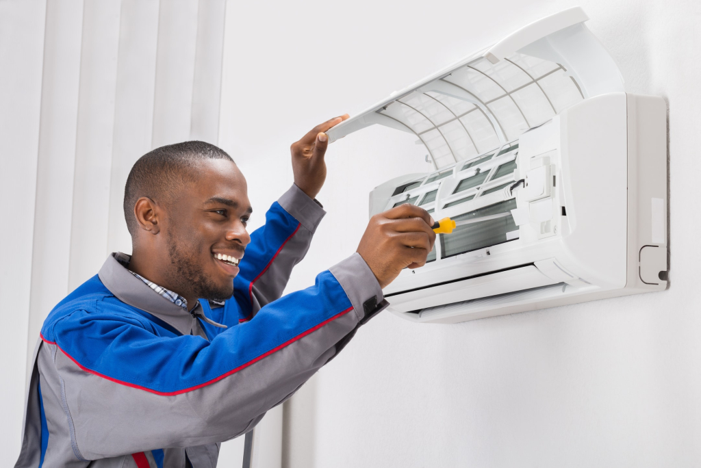 Picture of black guy doing Air Conditioner Maintenance