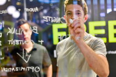 Picture of Man writing on glass board - Customer Acquisition Strategies